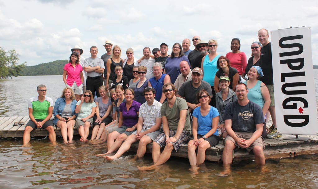 group of teachers on unplug'd conference sitting on the dock.